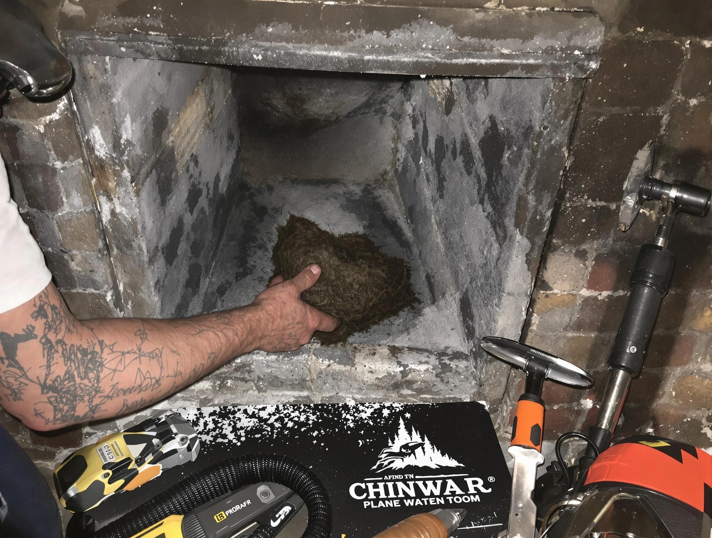 Westford Chimney Sweep safely removing debris and screening chimney in Westford, MA